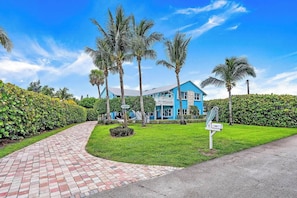Surfside Beach House - hammocks, body boards, beach chairs, coolers - we've got what you need to unwind and relax at our tropical oasis. #AerialView #BlueHouse #NatureLovers #BeachLovers #Surfers