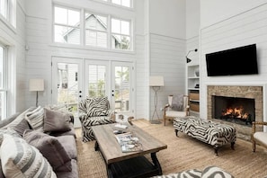 Two-story living area with wood-burning fireplace fireplace