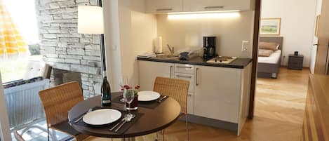 Pretty dining area with small kitchen