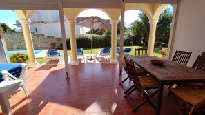 Large covered terrace near the pool for shaded al fresco dining 