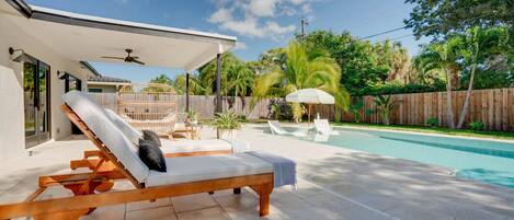 Heated saltwater swimming pool with lounging chairs