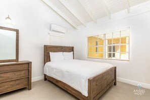 The bedroom features a queen bed