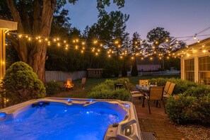 Stunning backyard w/ party lights, hot tub, outdoor dining & fire-pit!