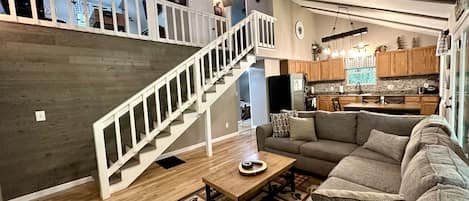 Vaulted ceiling great room overlooking the game room loft