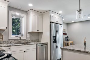 Kitchen with stainless steel appliances & granite counter tops.