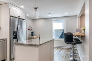 Kitchen with stainless steel appliances with custom folding breakfast bar.