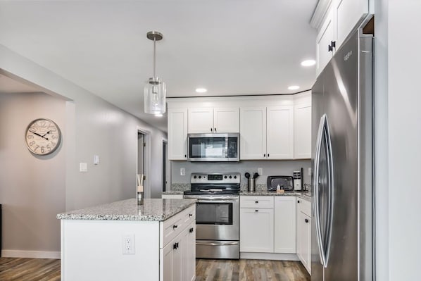Kitchen with stainless steel appliances & granite counter tops.