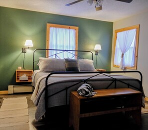 A king-size bed with cozy linens is the star of this spacious room. 
