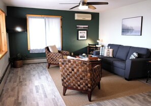 Inviting living room with solid, comfortable furniture, including a sleeper sofa
