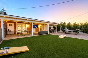 The backyard features cornhole, pingpong, Smart TV, BBQ, hammock, pool & more!