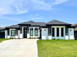 Three bedroom and four full bathrooms house with arcade and pool.