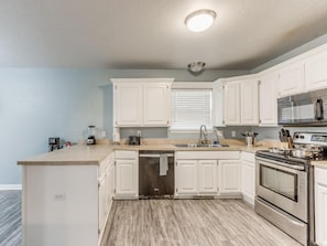 Unleash your inner foodie in this inviting and well-equipped kitchen.