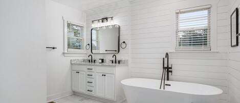 Master bathroom with new modern soaker tub, double vanity and separate shower