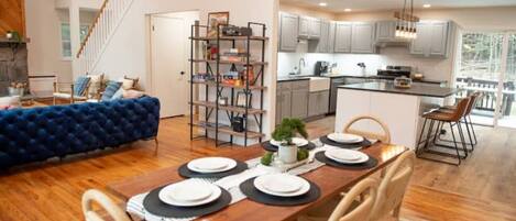 A view of the dining room into the living room (left) and kitchen (right)