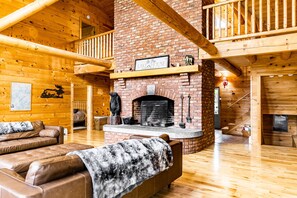 Chalet has huge logs and windows overlooking the lake giving it the true feel of lakefront retreat. Floor to ceiling wood-burning fireplace is impressive and great spot to enjoy the crackling sounds of fire while relaxing on comfortable leather couches.