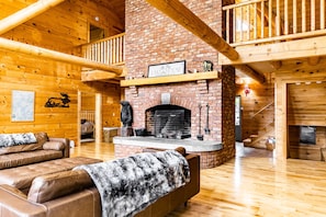 Chalet has huge logs and windows overlooking the lake giving it the true feel of lakefront retreat. Floor to ceiling wood-burning fireplace is impressive and great spot to enjoy the crackling sounds of fire while relaxing on comfortable leather couches.