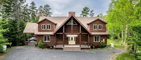 Front of the Chalet with a huge parking area plus another parking area by the road.