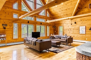 Chalet has huge logs and windows overlooking the lake giving it the true feel of lakefront retreat. Floor to ceiling wood-burning fireplace is impressive and great spot to enjoy the crackling sounds of fire while relaxing on comfortable leather couches.