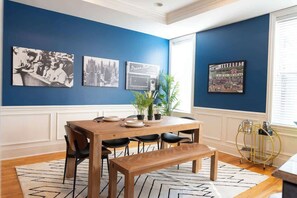 Large dining room with historic photos of Wrigley Field and old-school Chicago mob history. 