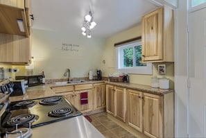 Kitchen, with the frontdoor beside it.