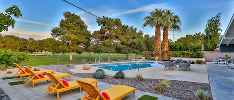 Exterior overseeing pool and golf course views.