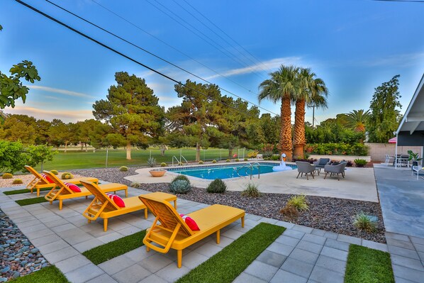 Exterior overseeing pool and golf course views.