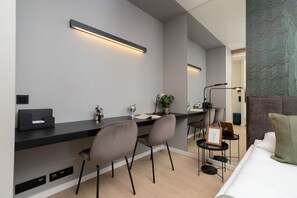 A dining and workspace area with a sleek table, chairs, and modern lighting.
