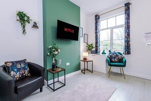 The living room benefits from a sofa bed and plenty of space to sit down and relax.