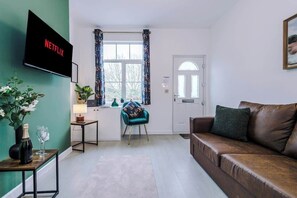 The living room benefits from a sofa bed and plenty of space to sit down and relax.