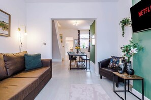 The living room benefits from a sofa bed and plenty of space to sit down and relax.