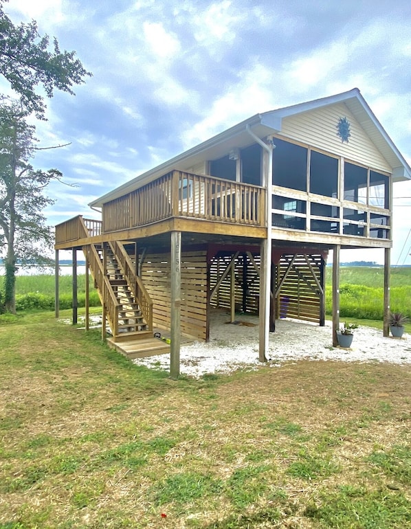 Side view of the cottage and deck space with gas grill