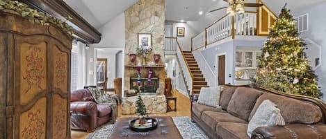 Great Room on main level features comfortable seating and a double-sided fireplace.