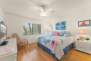 Master bedroom with king size bed featuring coastal vibes and soft bedding.