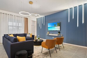 Modern living room with chic decor, LED accents, and cozy seating—relax in style!
