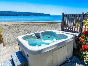 Imagine sinking into the warm bubbles of the hot tub while the soothing sound of waves in the distance washes over you