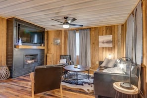 Cozy up by the fireplace in the living room.