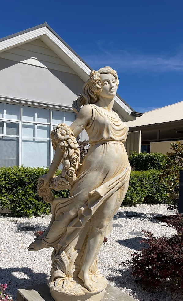 Custom made sandstone statue in front of the property