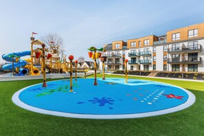 A colorful playground with water features, perfect for families with children.
