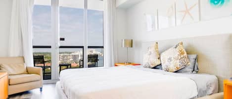 Huge bedroom with a King size bed, smart TV, and a direct balcony access