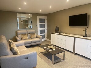 Lounge with 2 reclining sofas and Smart TV