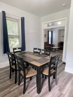 The dining room offers a spacious and inviting setting, perfect for enjoying meals with family and friends around a beautiful table, creating a warm and welcoming atmosphere.