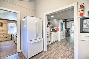Full sized refrigerator in kitchen