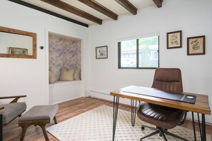 Whether you're logging on or logging off, this charming office offers a comfy desk setup and a closet-turned-reading nook with a record player to set the mood.