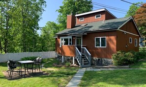 Outdoor seating area with Weber coal grill in neighborhood setting