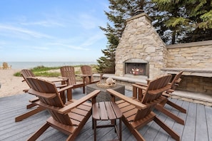 Back deck features an outdoor fireplace.