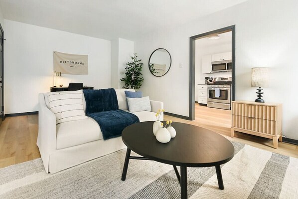 Relax in style! Cozy living room with comfy seating & a coffee table.
