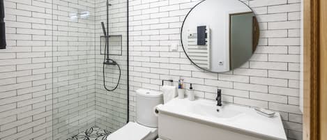 En-suite master bathroom with dual shower heads, towel warmer, and heated floors