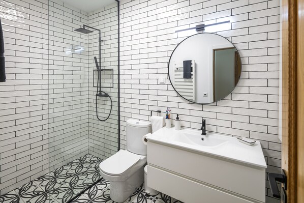 En-suite master bathroom with dual shower heads, towel warmer, and heated floors