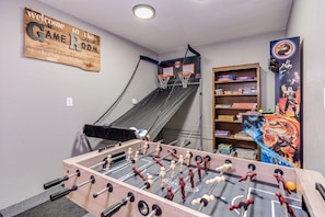 Game room- Arcade with 6k+ games, arcade basketball hoop, and foosball table.