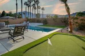 Backyard oasis with a putting green